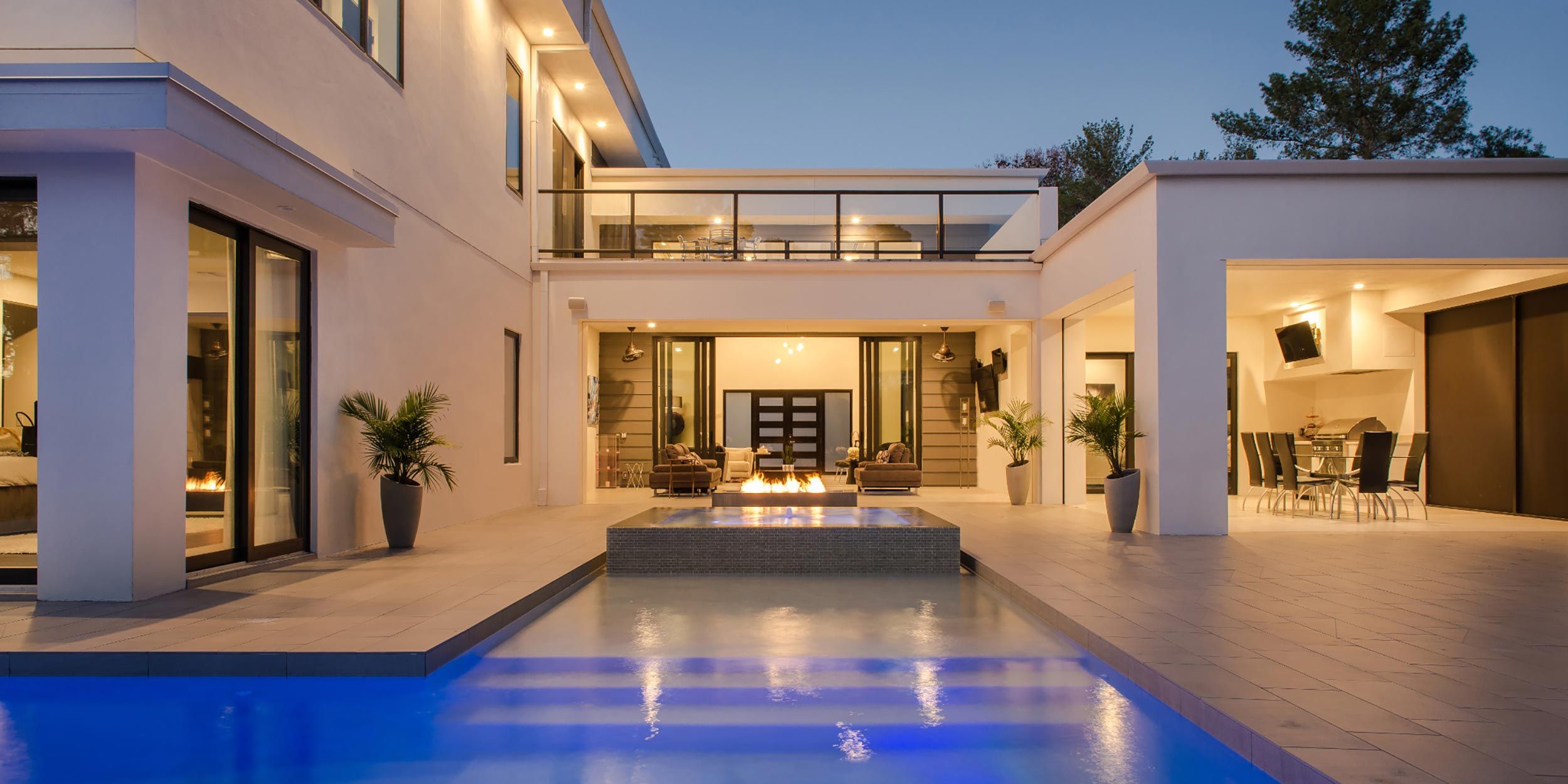 Modern house view from patio with pool and fireplace